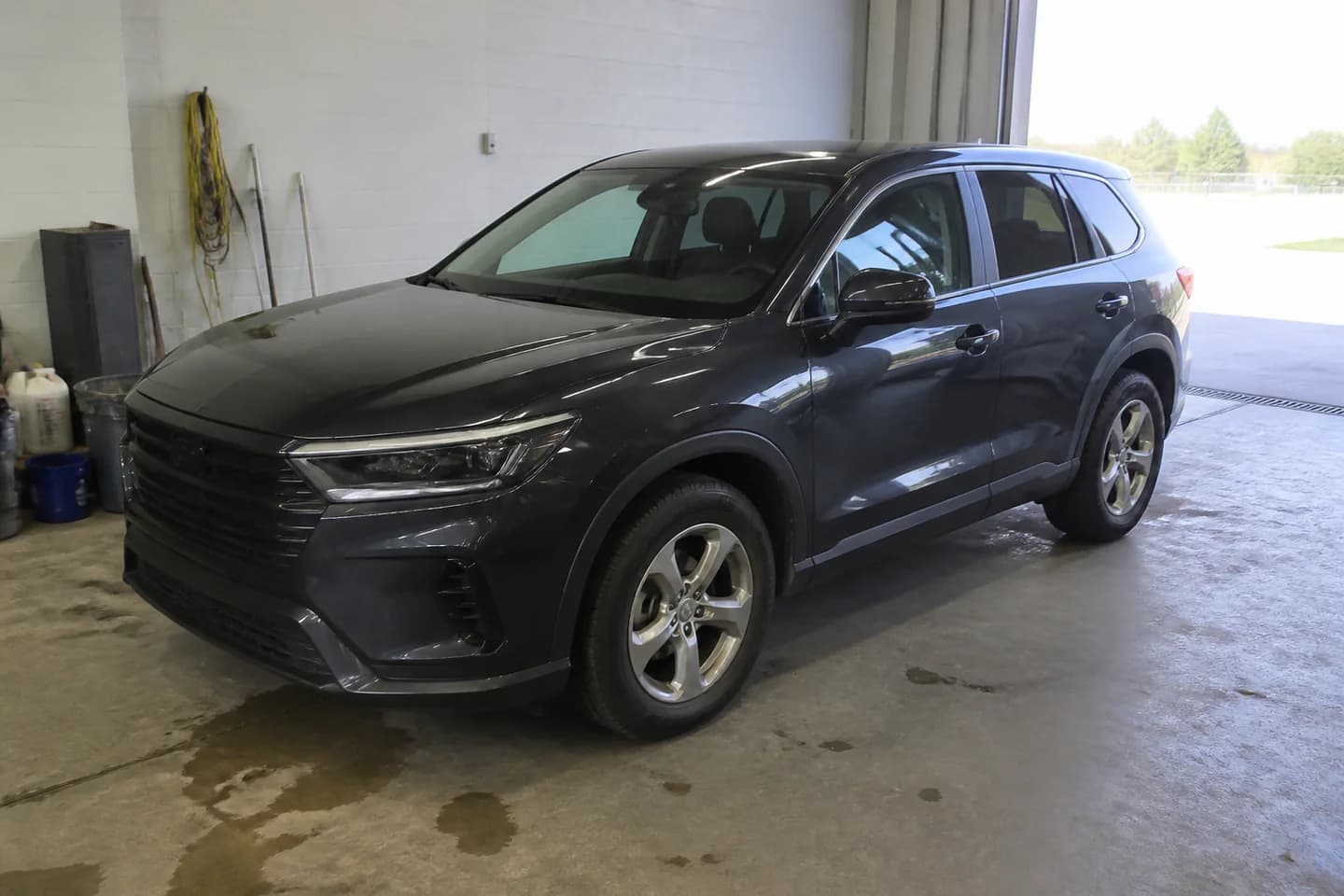 Dark graphite crossover in an ordinary preparation bay, photographed with mixed light and distracting surroundings.